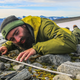 A researcher looks at an artifact found melted out of a Norwegian ice patch. Finds like these are becoming more common as the planet heats up.